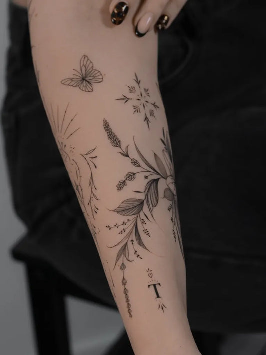 Small Fine Line Botanical Elements with Letters on Women Arm Tattoo by @india.tattooartist