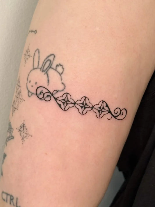 Small Fine Line Bunny and Swirls on Women Arm Tattoo by @amoreee.tattoo