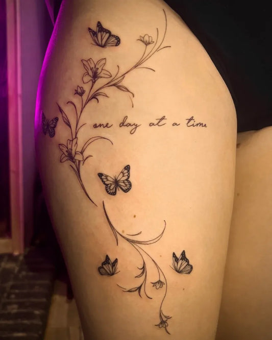Small Fine Line Butterflies and Flowers on Women Thigh Tattoo by @inkedbykate_