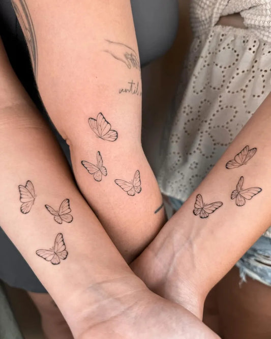 Small Fine Line Butterflies on Couple Arms Matching Tattoo by @catmorfin.tattoo