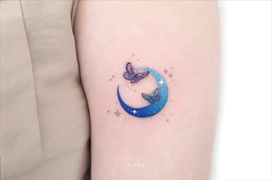 Small Fine Line Butterfly Blue Moon Tattoo on Women Arm by @mood_bkk