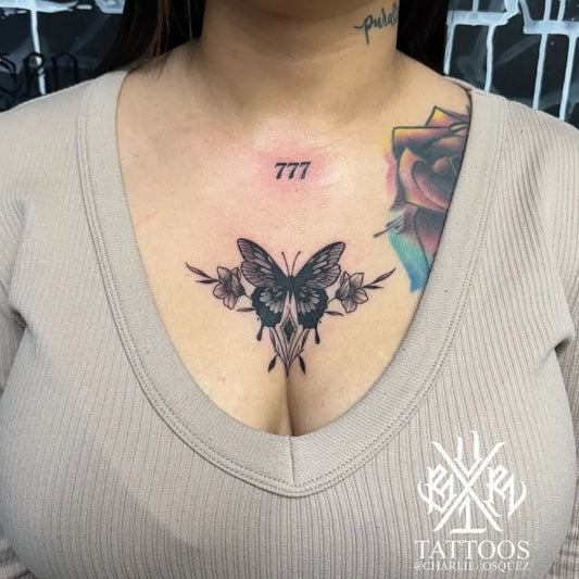 Small Fine Line Butterfly Flowers 777 on Women Sternum Tattoo by @charliebosquez