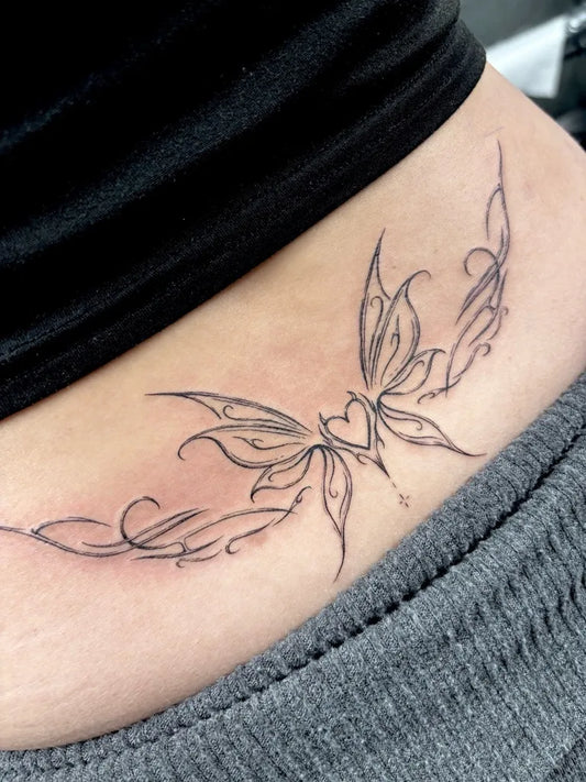 Small Fine Line Butterfly Heart Tattoo on Women Lower Back by @boysdontcry_tattoo