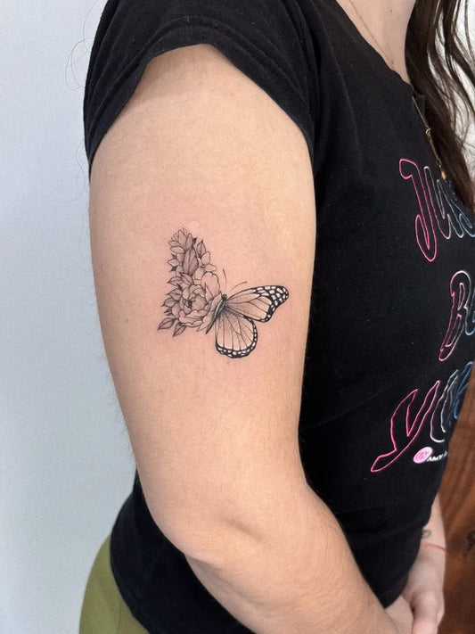 Small Fine Line Butterfly and Flowers on Women Upper Arm Tattoo by @tach.art