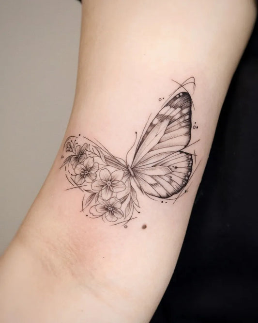 Small Fine Line Butterfly and Flowers on Women Wrist Tattoo by @yulight_tattoo