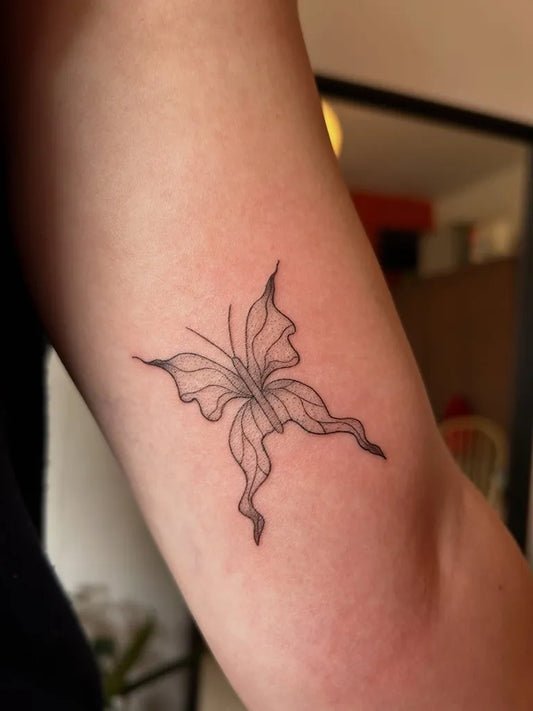 Small Fine Line Butterfly on Women Upper Arm Tattoo by @r.o.tattoos