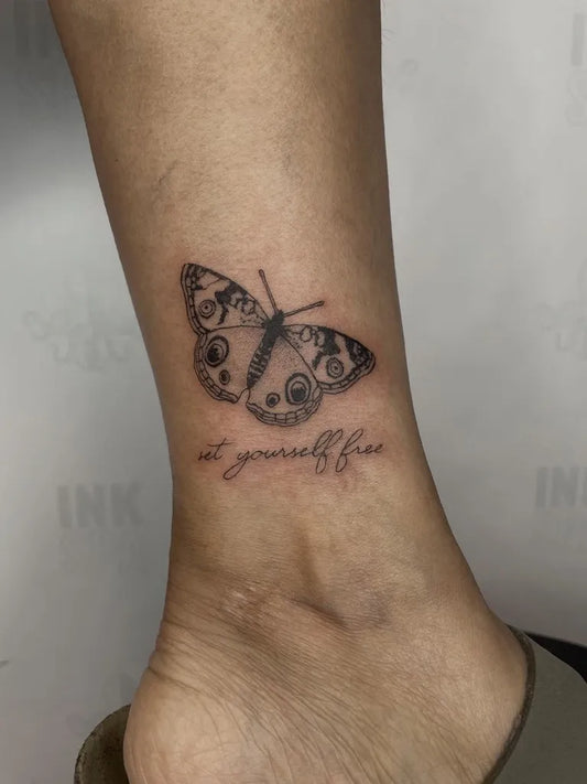 Small Fine Line Butterfly with Quote on Women Ankle Tattoo by @art.by.mkm