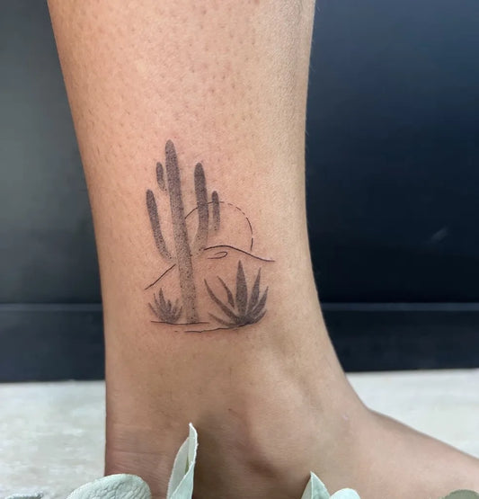 Small Fine Line Cactus Sunset Tattoo on Women Leg by @kiristattoo