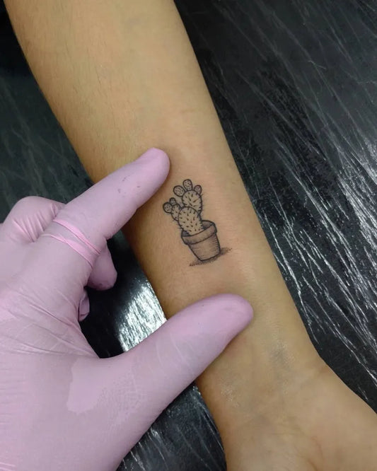 Small Fine Line Cactus in Pot Tattoo on Women Forearm by @victorbuenotattoo