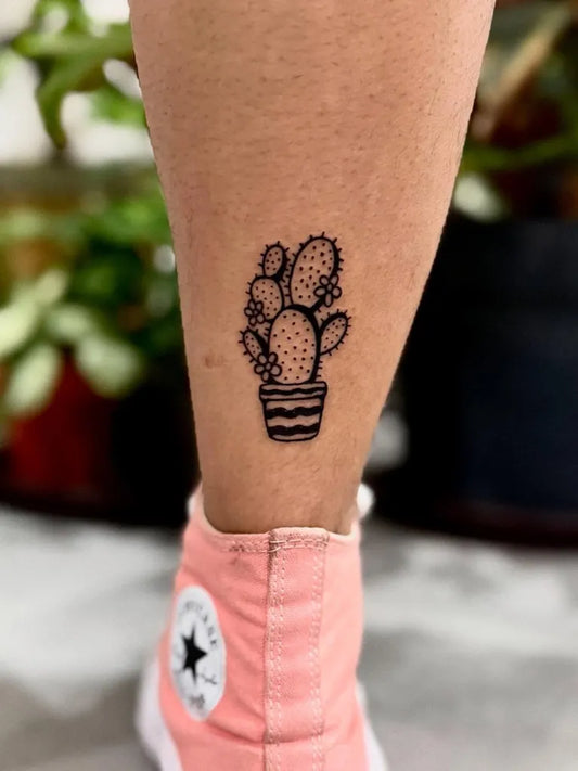 Small Fine Line Cactus in Pot Tattoo on Women Leg by @reginamerino.tatt