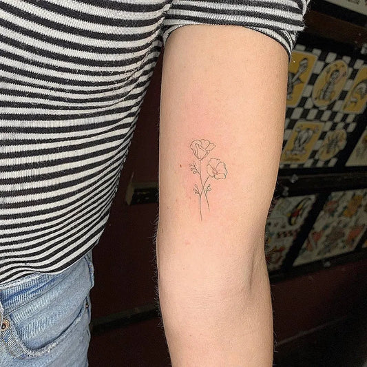 Small Fine Line California Poppies Tattoo on Women Inner Arm by @small.tattoos