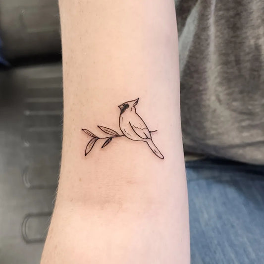 Small Fine Line Cardinal Bird on Branch Tattoo on Women Forearm by @isabellanemethtattoos