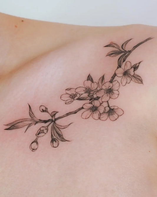 Small Fine Line Cherry Blossom Branch Tattoo on Women Collarbone by @jennyli_tattoo