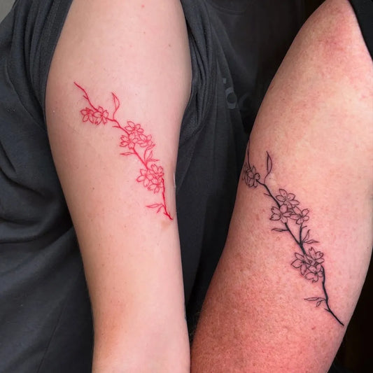 Small Fine Line Cherry Blossom Branch on Couple Arm Matching Tattoo by @kwa.tattoo