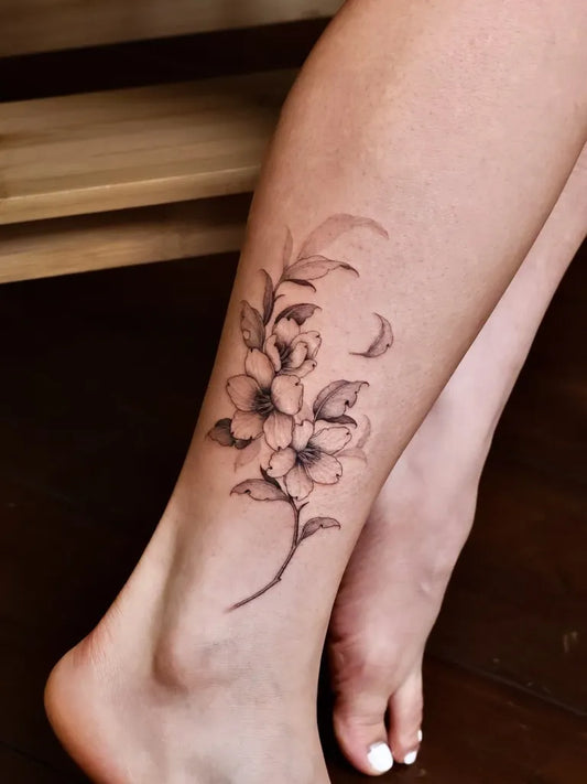 Small Fine Line Cherry Blossom Branch on Women Leg Tattoo by @maeul.tt