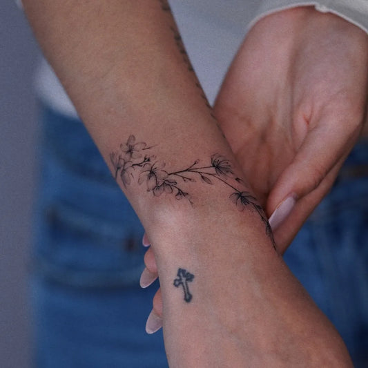 Small Fine Line Cherry Blossom Cross on Women Wrist Tattoo by @jaejari_tattoo