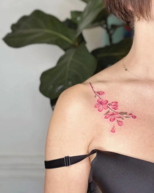Small Fine Line Cherry Blossom Tattoo on Women Collarbone by @eva_tattooist