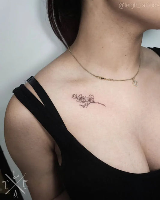 Small Fine Line Cherry Blossom on Women Collarbone Tattoo by @leighs_tinytatts