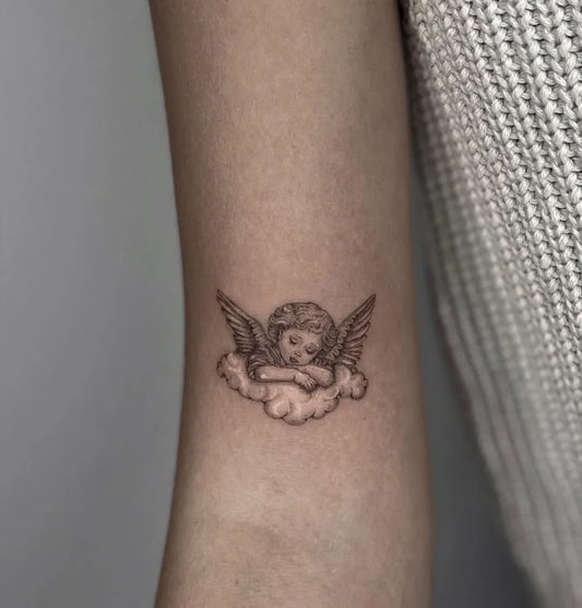 Small Fine Line Cherub Cloud Tattoo on Women Arm by @rangerstudio