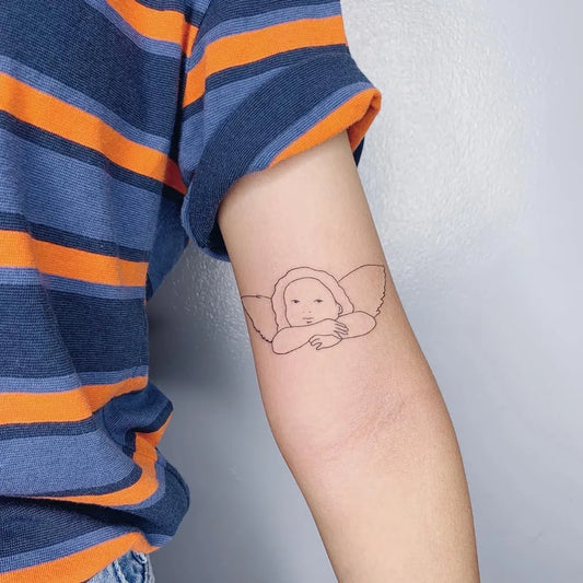 Small Fine Line Cherub Tattoo on Women Arm by @theuncannie