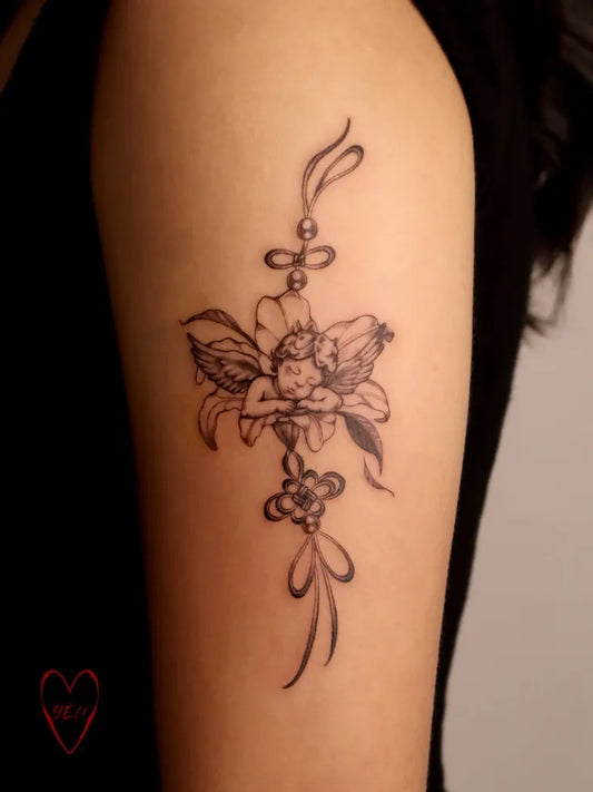 Small Fine Line Cherub and Flowers Tattoo on Women Arm by @inkedwithyeu