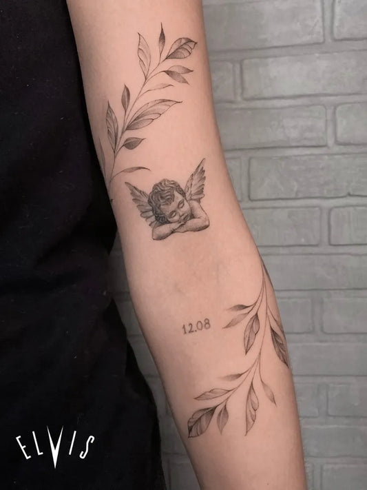 Small Fine Line Cherub and Leaves Tattoo on Women Arm by @elvis_pachamamatattoo