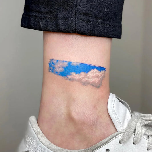 Small Fine Line Cloud Tattoo on Women Ankle by @graycodetattoo