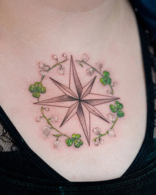 Small Fine Line Compass Lily of the Valley Shamrock on Women Chest Tattoo by @suya_ink