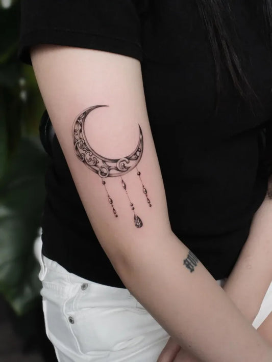 Small Fine Line Crescent Moon and Dreamcatcher Tattoo on Women Upper Arm by @kaki_claratattoos