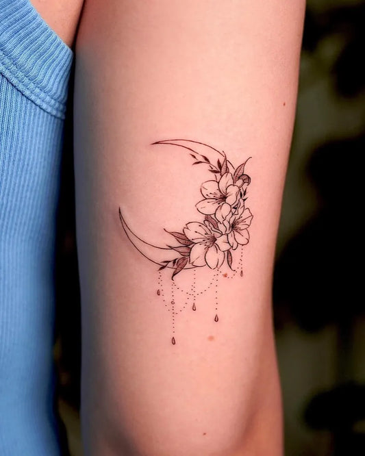 Small Fine Line Crescent Moon and Flowers Tattoo on Women Arm by @tattoo.gu