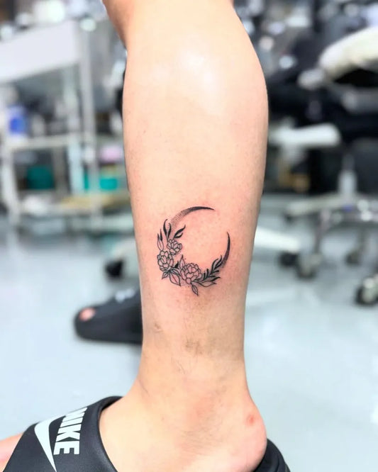 Small Fine Line Crescent Moon and Flowers Tattoo on Women Leg by @ncn.tattoo.cn