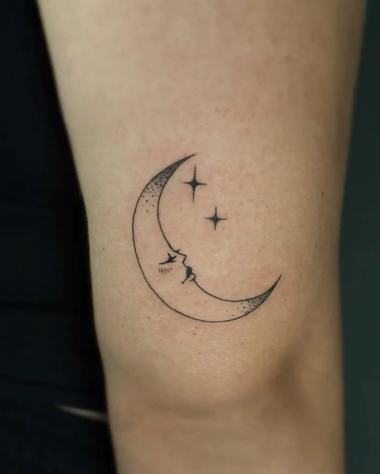 Small Fine Line Crescent Moon with Face and Stars Tattoo on Women Arm by @vrtualgh0ul