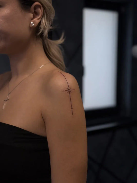 Small Fine Line Cross on Women Shoulder Tattoo by @elle_aarte