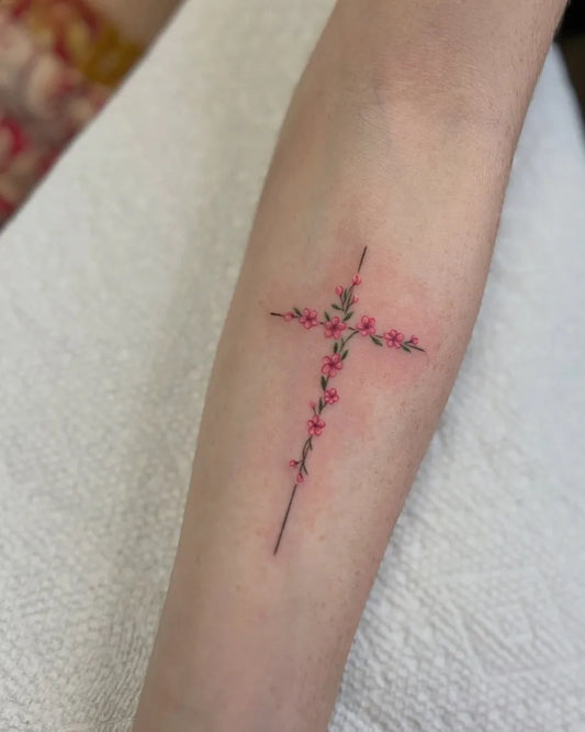 Small Fine Line Cross with Flowers on Women Arm Tattoo by @slumbabe