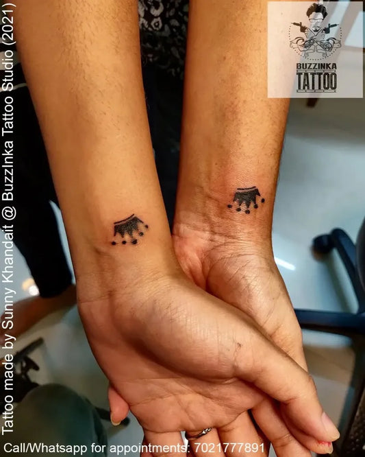 Small Fine Line Crown Tattoo on Women Wrist by @buzzinkatattoos_mumbai