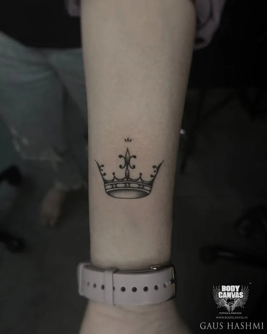 Small Fine Line Crown Tattoo on Women Wrist by @gaus_hashmi