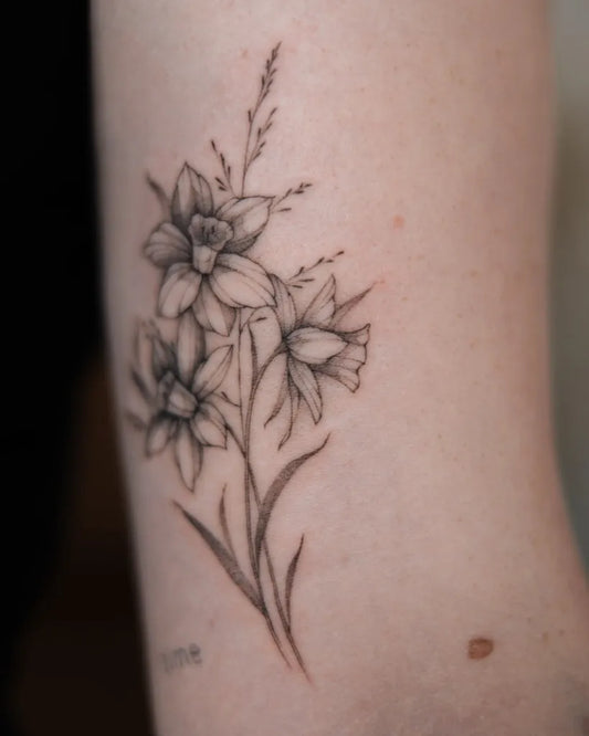 Small Fine Line Daffodil Bouquet Tattoo on Women Arm by @betstattoo