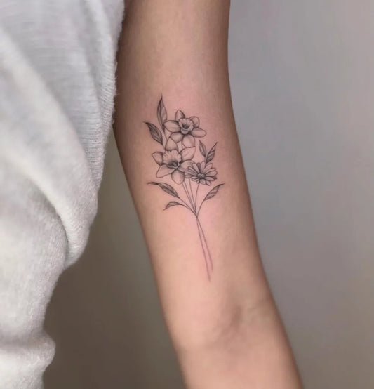 Small Fine Line Daffodil Flowers Tattoo on Women Arm by @bluebell.tatts