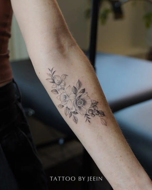 Small Fine Line Daffodil Flowers Tattoo on Women Arm by @tattoobyjeein