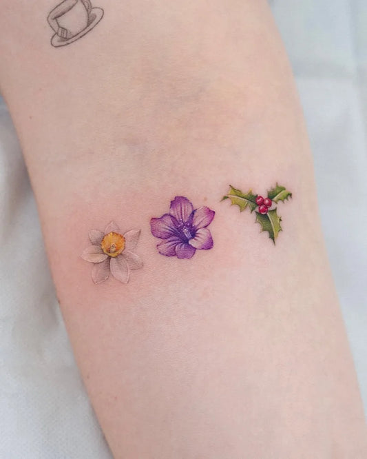 Small Fine Line Daffodil Holly Tattoo on Women Forearm by @suya_ink