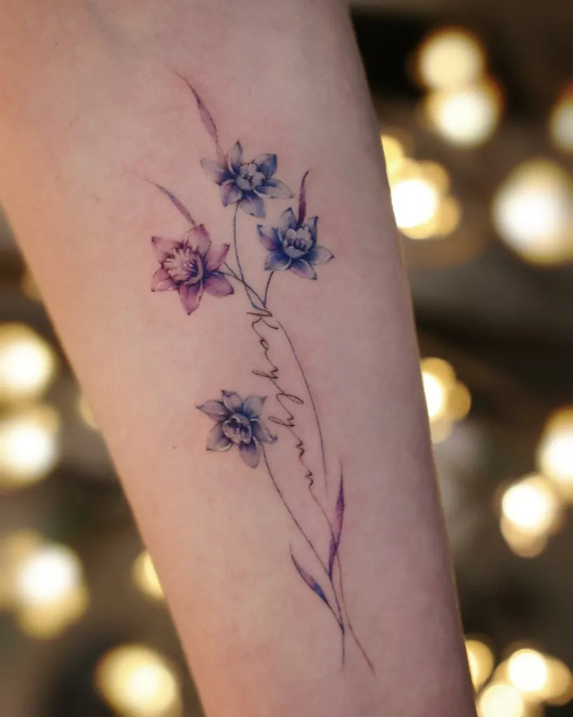 Small Fine Line Daffodil Tattoo on Women Arm by @vivi_tattooer