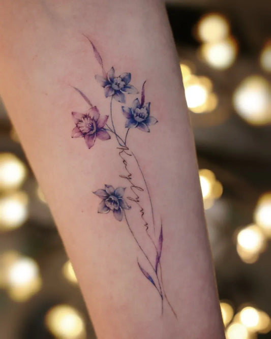 Small Fine Line Daffodil Tattoo on Women Arm by @vivi_tattooer