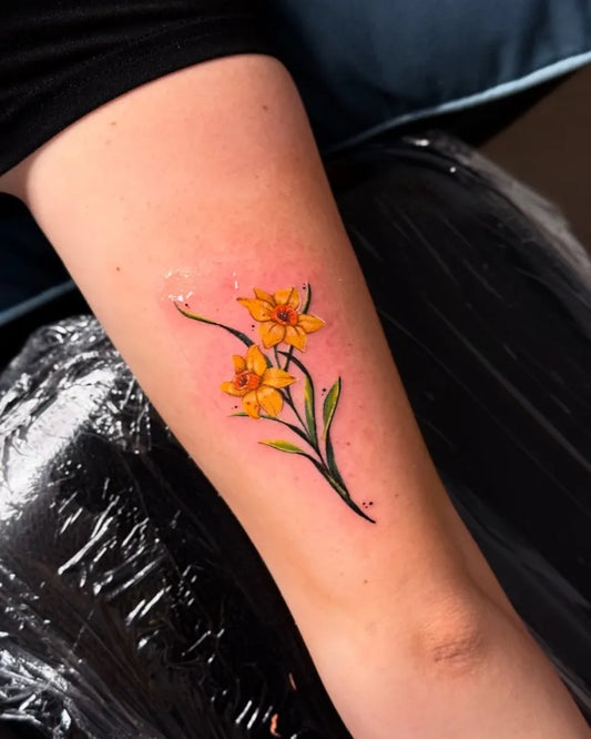 Small Fine Line Daffodil Tattoo on Women Arm by @wixien_artworks