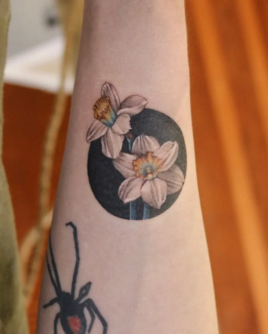 Small Fine Line Daffodil and Black Circle Tattoo on Women Forearm by @shino_rainfall