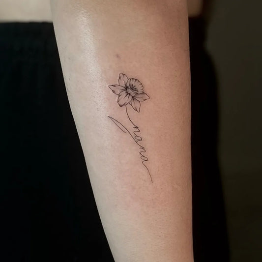 Small Fine Line Daffodil and Nana Tattoo on Women Arm by @ace_ink_tattoos