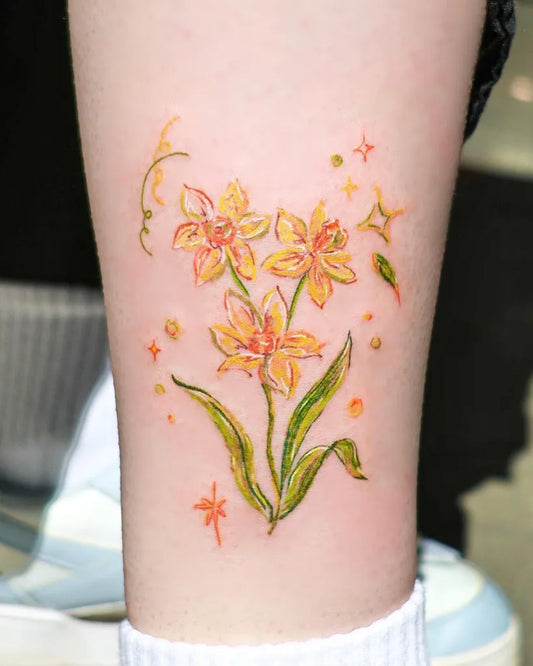 Small Fine Line Daffodil and Stars Tattoo on Women Leg by @dahlia_tattooist