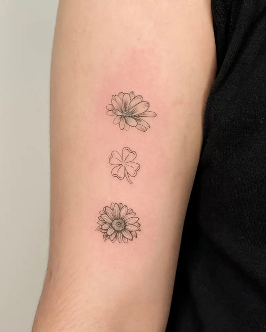 Small Fine Line Daisy Clover Shamrock Sunflower Tattoo on Women Arm by @tangkytattoo