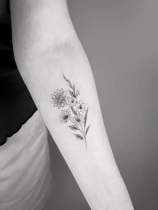 Small Fine Line Daisy Flowers Tattoo on Women Arm by @shan.6tattoo