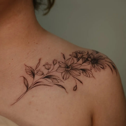 Small Fine Line Daisy Flowers Tattoo on Women Collarbone by @theblondietattoos
