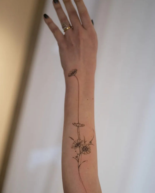Small Fine Line Daisy Flowers Tattoo on Women Forearm by @nadiatattooer